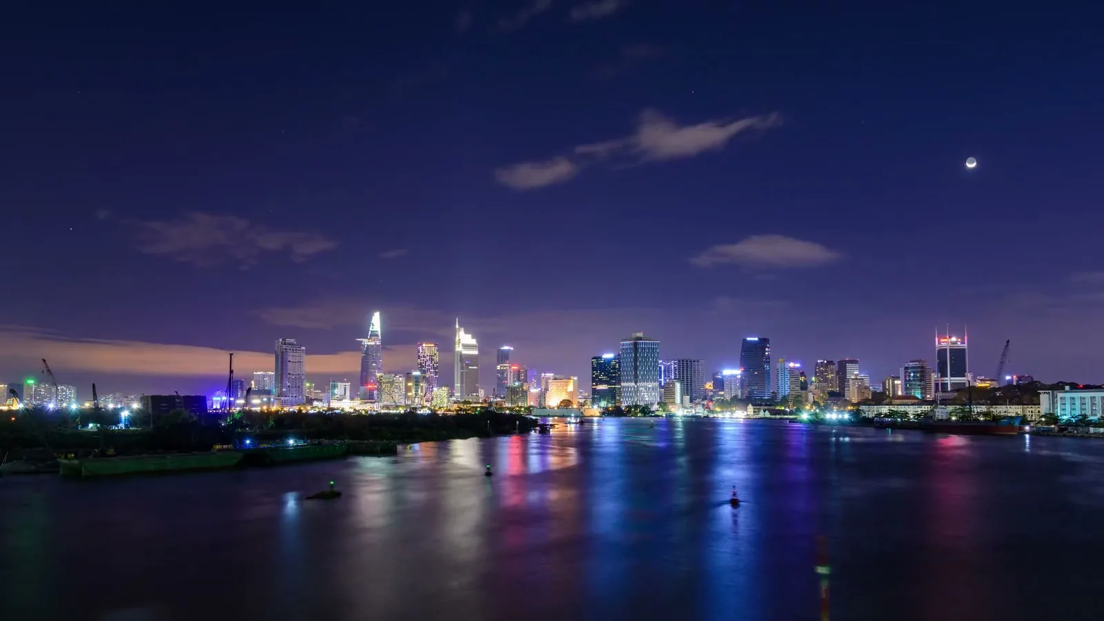 Illustrative city skyline and waterfront at night